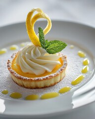 A dessert plate featuring a lemon tart with a swirl of whipped cream and a sprig of mint