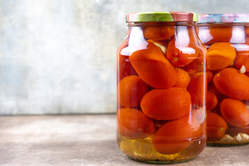 Pickled tomatoes in jars.