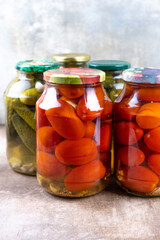 Pickled cucumbers and tomatoes in jars.