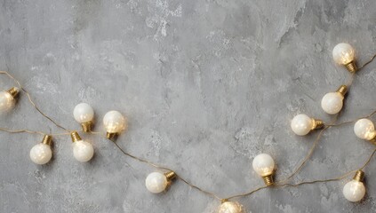 Festive String Lights on Gray Concrete Background.