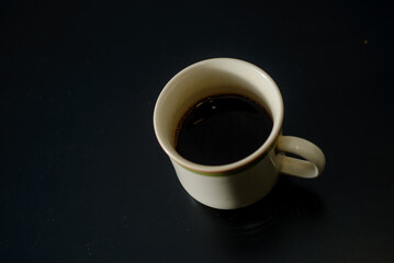 A cup of freshly brewed strong and black homemade coffee for a good mood