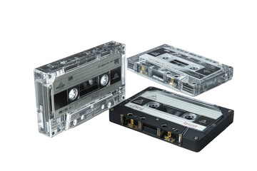 Obraz premium Three Cassette Tapes in Clear and Black Cases on Transparent Background Retro Music Audio Technology Vintage Sound Recording Media Analog Format Still Life Detailed Presentation
