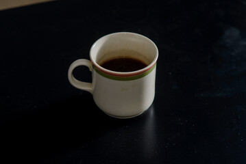 A cup of freshly brewed strong and black homemade coffee for a good mood