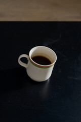 A cup of freshly brewed strong and black homemade coffee for a good mood