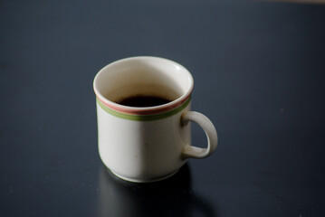 A cup of freshly brewed strong and black homemade coffee for a good mood