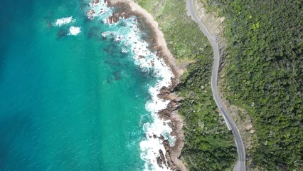 Selbstklebende Fototapeten Küste Coastal road on the beautiful ocean coast of Australia. Blue sea and wild coast view from above.  © pettys