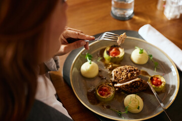 Close up of businesswoman eating in restaurant during lunch time.