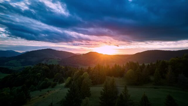 Hyperlapse aerial view of vibrant sunset sky over mountain forest , carpathians landscape