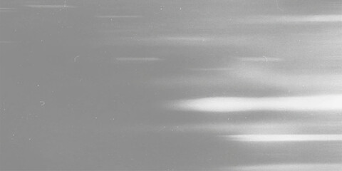 A sleek, brushed metallic texture provides a shiny stainless steel surface for a subtle, gray aluminum backdrop