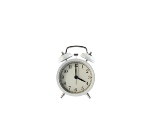 A white alarm clock with black hands, bells, and numbers sits on a dark background