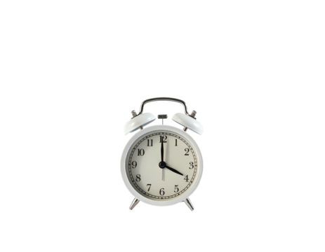 A white alarm clock with black hands, bells, and numbers sits on a dark background