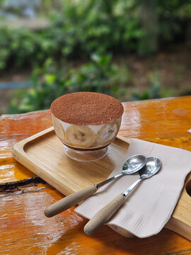 Homemade banoffee banana cream cake serving in clear cup