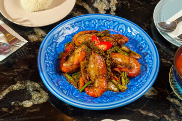 Vibrant Thai Prawn and Bell Pepper Stir-fry on a Blue Plate