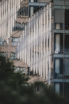View of the modern architecture with reflective glass and vertical panels create a mesmerizing pattern against the sky, New York, New York, United States.