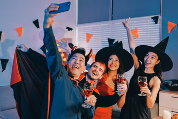 Fototapeta premium Friends enjoying a Halloween party at a bar making a toast