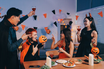 Friends enjoying a Halloween party at a bar making a toast