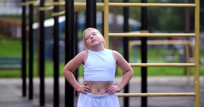 Beautiful teenage girl doing sports at an outdoor stadium