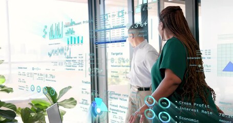 Woman reviewing financial reports, hearing door open and collaborating on data overlays with man - Powered by Adobe