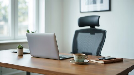 Modern minimalist office workspace with laptop, coffee cup, smartphone, notebook, and plant on wooden desk in bright interior with ergonomic chair