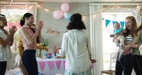 Guest greeting mom-to-be while guiding toward desserts for baby shower with animated confetti