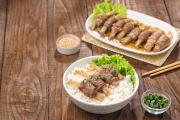 Beef enoki roll is a rolled sheet of beef filled with enoki mushrooms.
