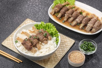 Beef enoki roll is a rolled sheet of beef filled with enoki mushrooms.