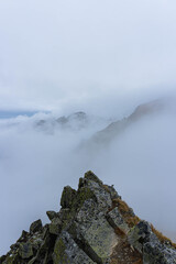 sharp ridge rocky peak over big clouds on autumn day in carpathians 