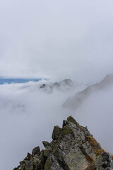 sharp ridge rocky peak over big clouds on autumn day in carpathians 