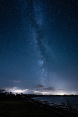 Starry night with the Milky Way on a coast in Brittany.