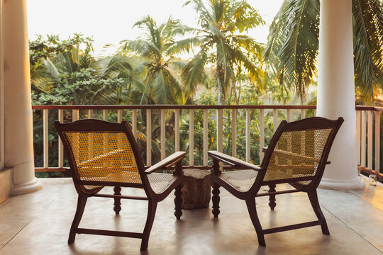 Cozy Tropical Balcony With Chairs And Palm Tree View At Exotic Resort - Powered by Adobe