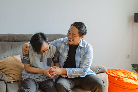 Father and Son Sharing a Heartwarming Moment of Laughter at Home