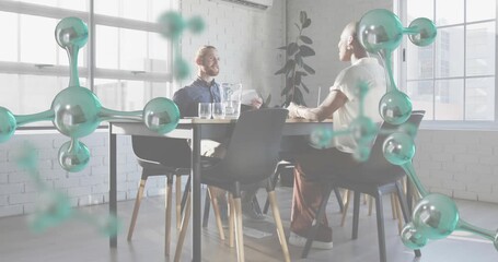 Molecular graphic floating above conference table initiating team reviewing biotech model gesturing - Powered by Adobe