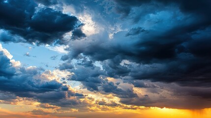 Fototapeta premium Dramatic Sky At Sunset With Dark Clouds And Golden Sunlight At Low Angle View