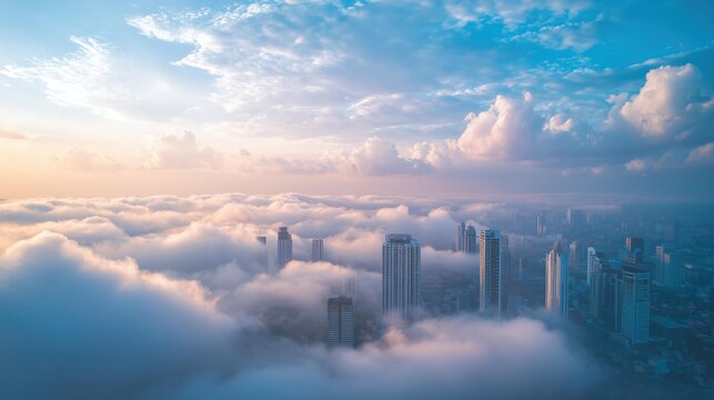 A breathtaking aerial view of skyscrapers emerging from a sea of clouds at sunset, creating a surreal urban landscape.