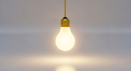 Single glowing incandescent light bulb hanging from a yellow cord, isolated on a plain background