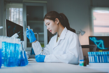 Fototapeta premium Female scientist doing research, holding test tube