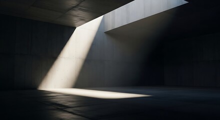 Sunlight streams through a geometric opening in a dark, minimalist concrete room, creating dramatic shadows and highlights on the floor
