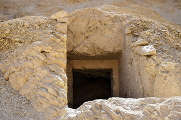 Entrance to cave in rocky desert. Valley of the Kings in Luxor, Egypt. Close-up.