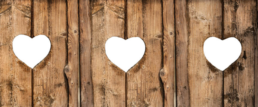 old wooden plank background with three heart shapes holes on a transparent background