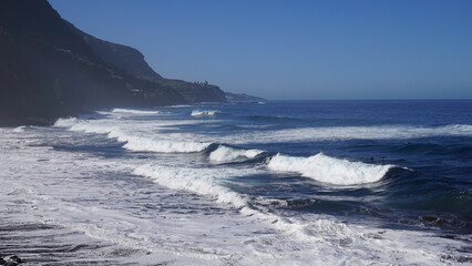 Tenerife landscapes, picturesque coastline, powerful ocean waves at sunset, Canary Islands