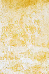 Textured Yellow Wall Surface with White and Brown Spots