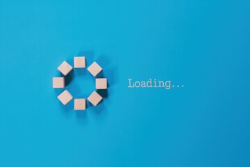 Creative concept of a loading screen with a circular progress bar made of wooden blocks on a blue background, symbolizing waiting, buffering, and data transfer