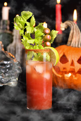 Bloody Mary cocktail. Tomato juice and vodka, garnished with celery stalk, lime and olives. Halloween party ideas.  