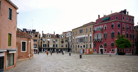 Empty Venetian square with traditional colorful houses and historic architecture in Venice, Italy. © Viola