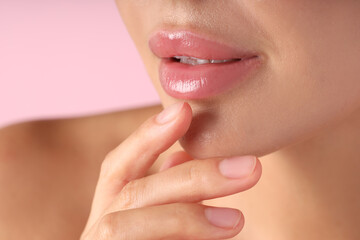 Woman with beautiful lips on pink background, macro view