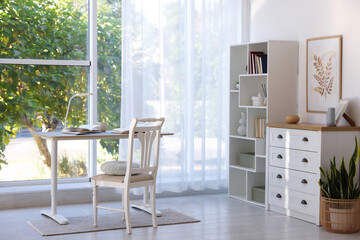 Stylish living room with table, chair and shelving unit. Interior design