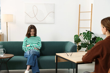 Professional psychologist working with teenage girl in office