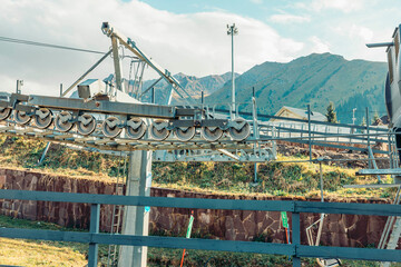 A cable car system in the mountains, surrounded by lush greenery and rocky peaks. The scene captures the essence of a vacation destination.