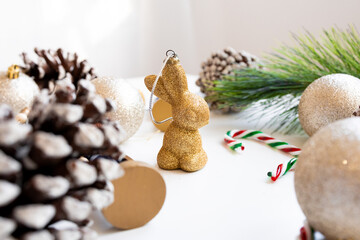 Festive holiday decor with glittery rabbit ornament and pinecones