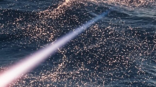 Fiery Meteor Streaks Across Dark Ocean Surface at Night.